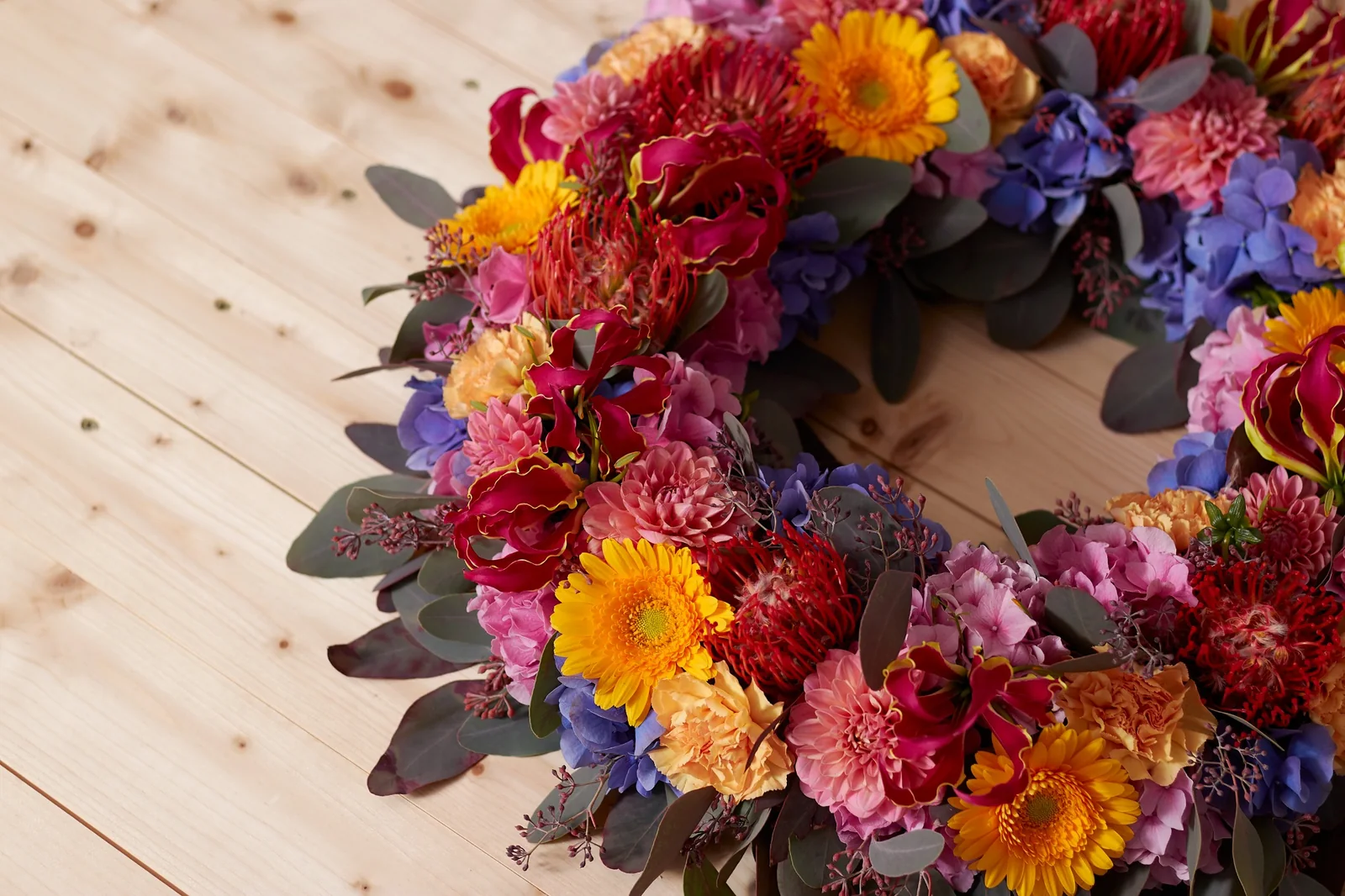 Urnenschmuck mit gelben und rosafarbenen Blüten, Rosen und lockerem Naturgrün